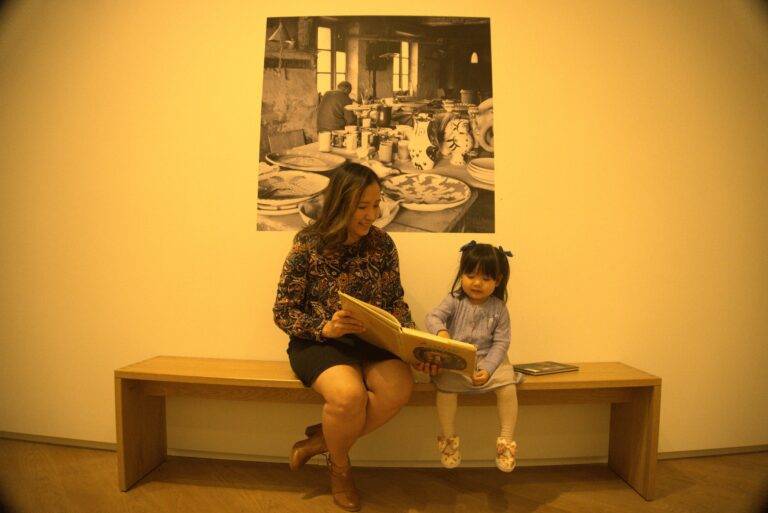 A mother and daughter reading a book together